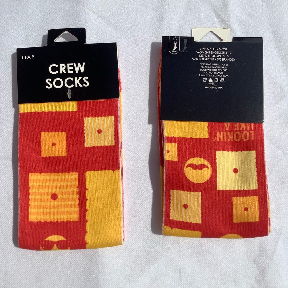 A Pair of Kelloggs Themed Snack Piece Face Crew Socks Red Orange and Yellow